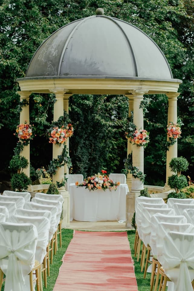 Elegant event venue with floral columns and hanging flower arrangements